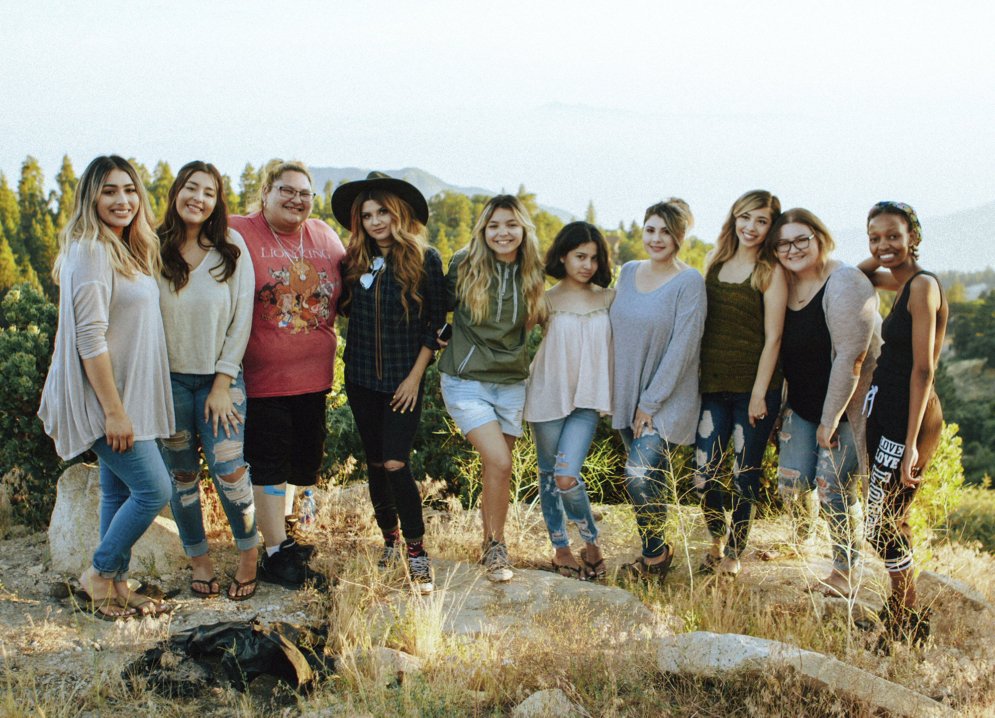 Groupd of people smiling at an outdoor retreat.